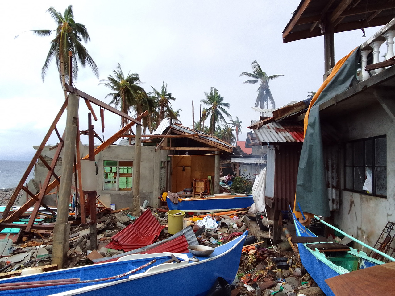 Destroyed houses and boats lie strewn about after Cyclone Rai hit the Philippines.