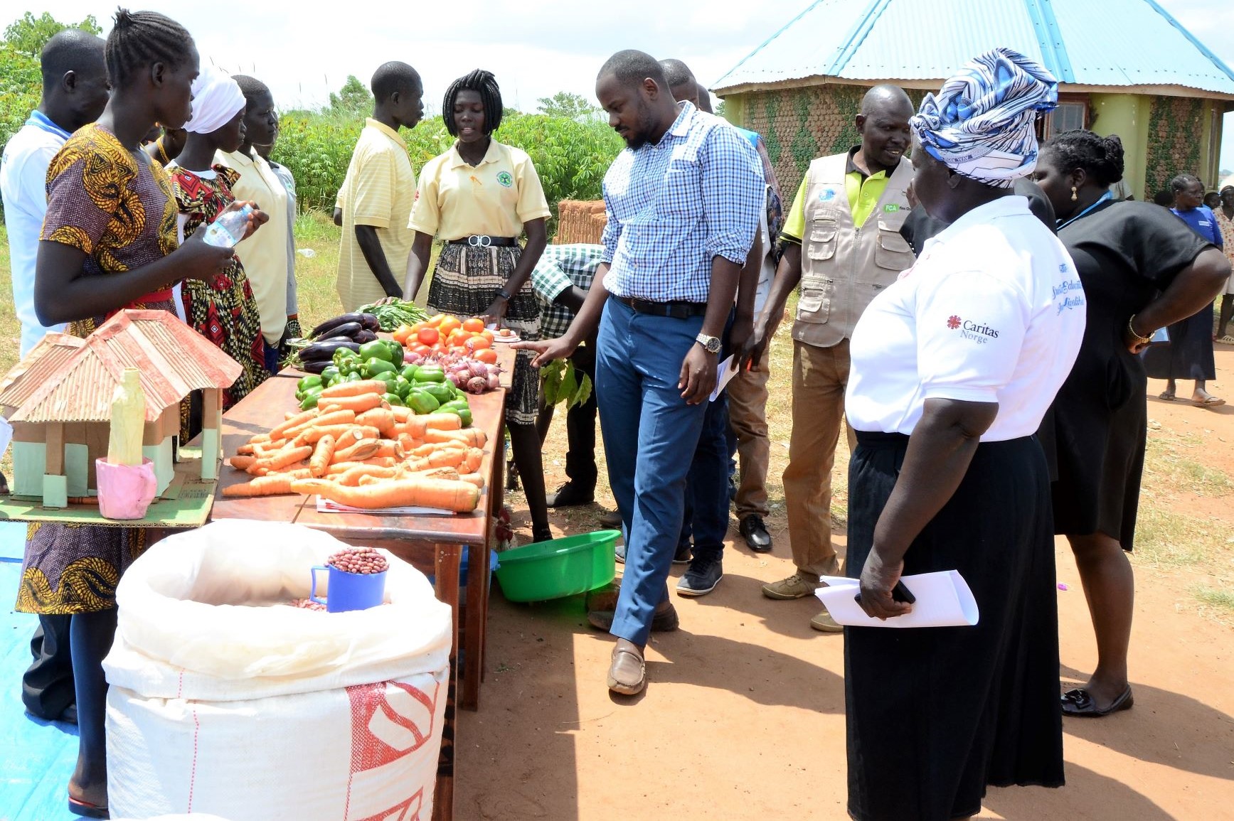 Home-grown vegetables are presented to the management of Bidibidi and Caritas Uganda in connection with graduation.