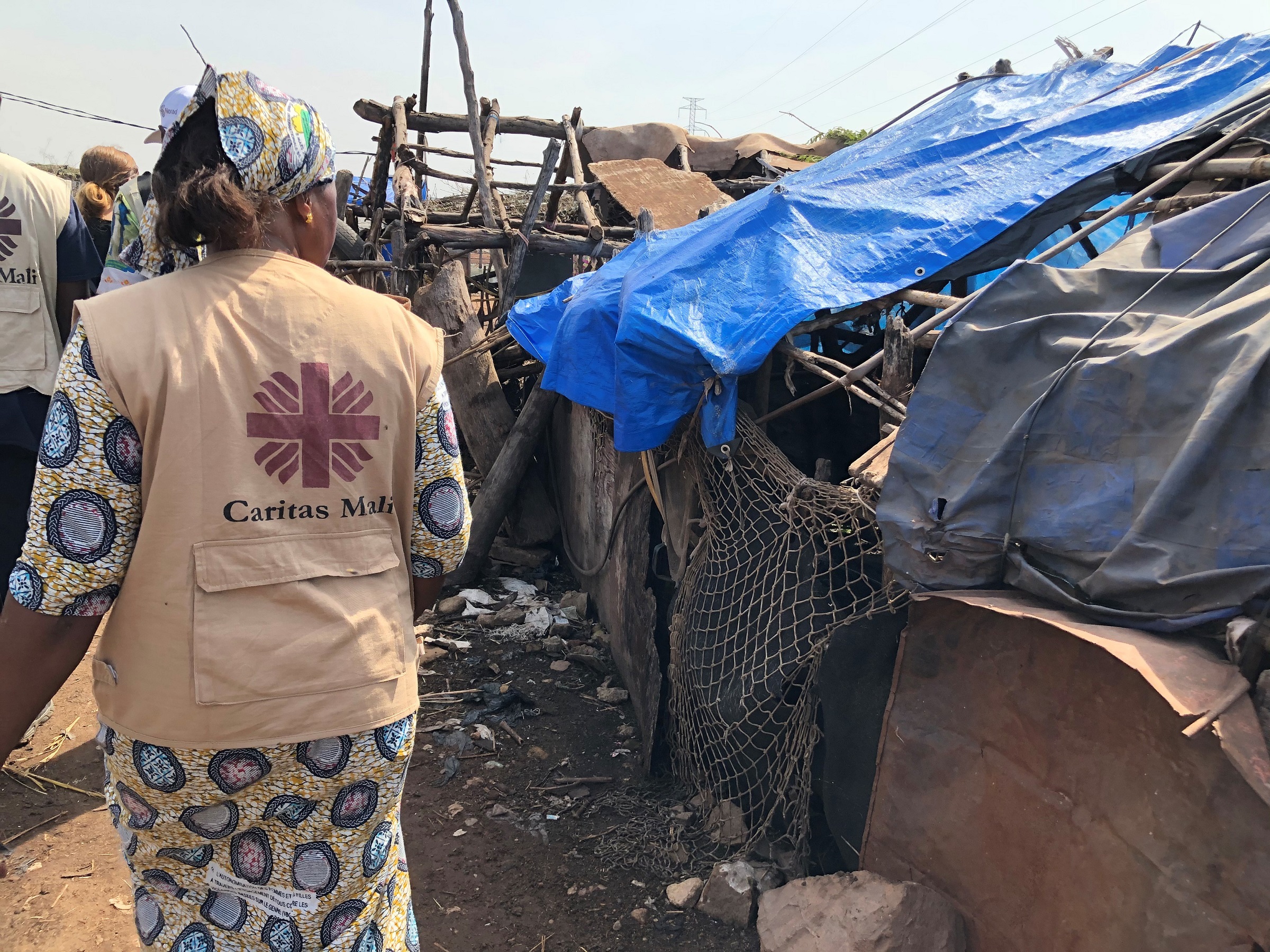 Female aid worker from Caritas Mali visits tent camp with internally displaced people