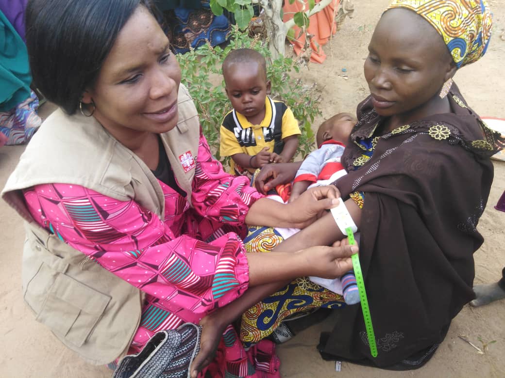 Ansatt i Caritas Nigeria gir veiledning i ernæring til kvinner med barn i delstaten Borno
