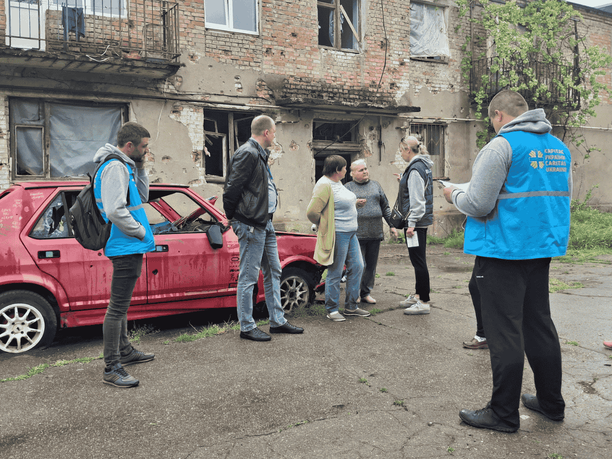 Hjelpearbeidere fra Caritas Ukraine kartlegger ødeleggelsene på et hus. (Foto: Caritas International)